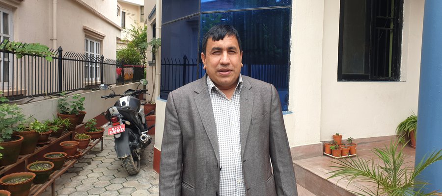 A picture of Amar Timalsina standing outside a building in Nepal