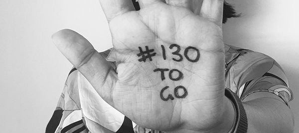 The palm of a hand has written on it '#130 to go'