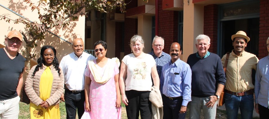 The Norway team visit Naini Hospital in India and are pictured smiling alongside three of the hospital staff