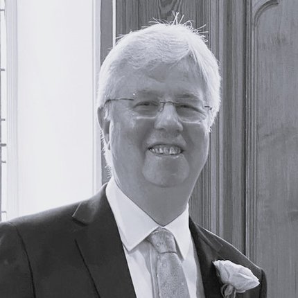A photo of a white British man in a suit
