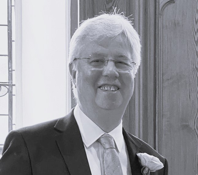 A photo of a white British man in a suit