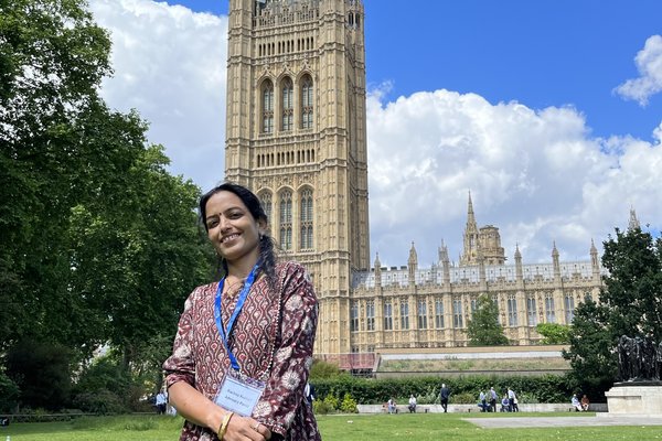 Rachna poses outside the UK Parliament building