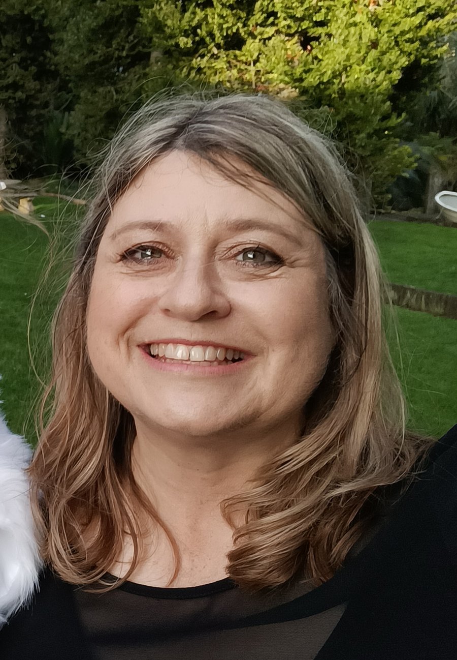 Odele, a white woman with light coloured hair, smiling at the camera