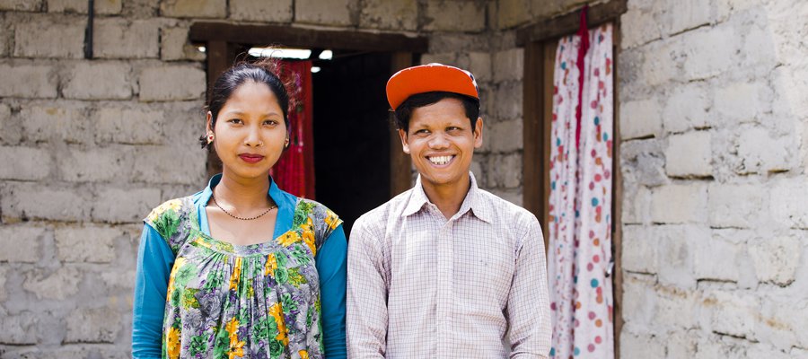 Young people in Nepal stand outside their home