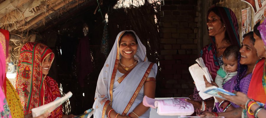 A gathering of women in brightly colored saris