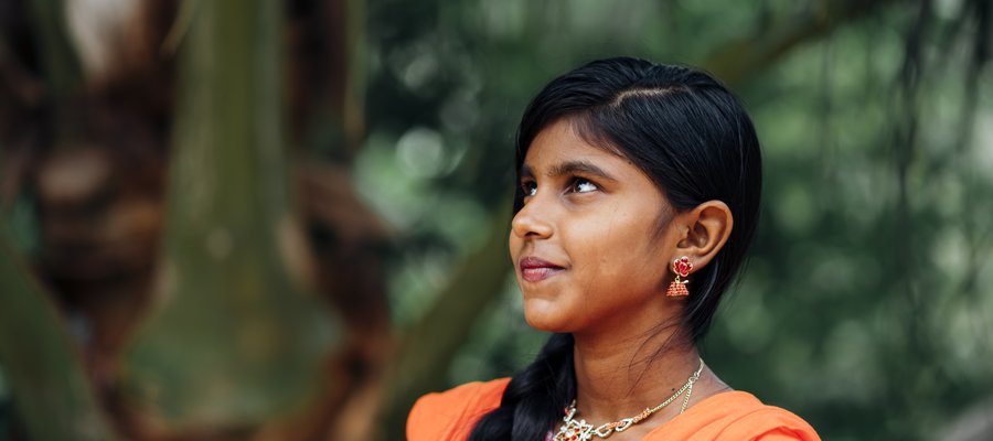 A young woman in Sri Lanka stands proudly