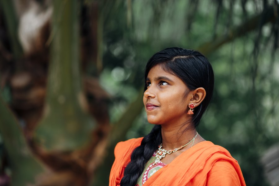 A young woman in Sri Lanka stands proudly