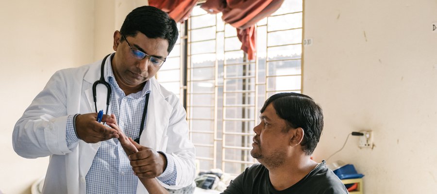 Dr Benjamin examines a patient at DBLM Hospital in Bangladesh