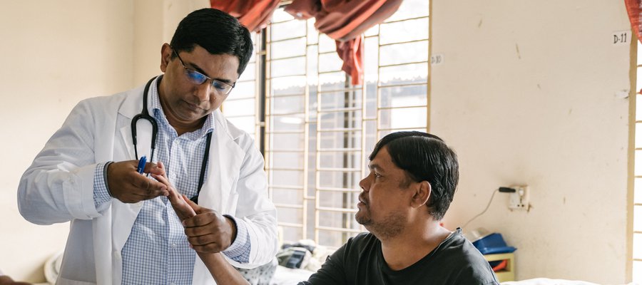 Dr Benjamin examines a patient at DBLM Hospital in Bangladesh