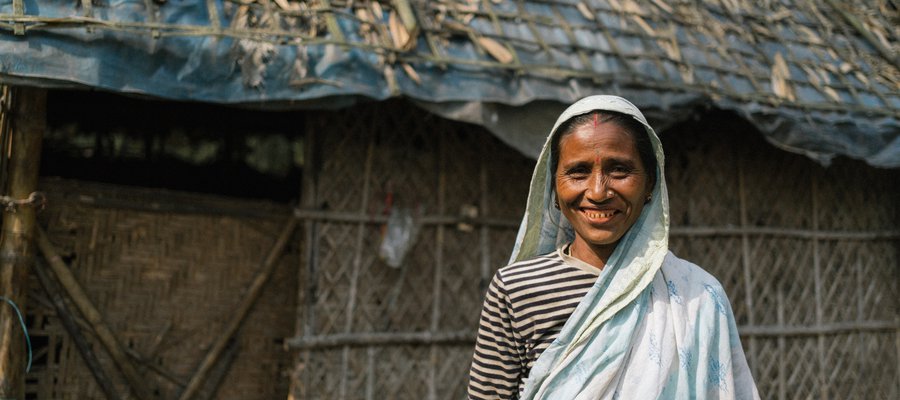 A lady who has benefited from the project smiles to camera