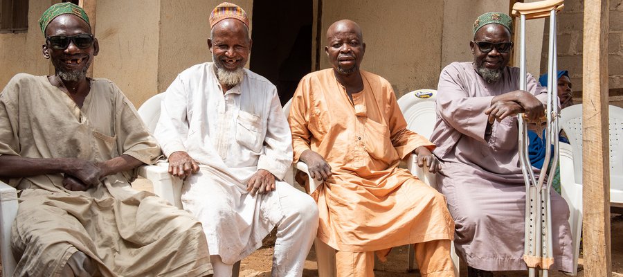A group of four men at the Dakwa Settlement in Nigeria