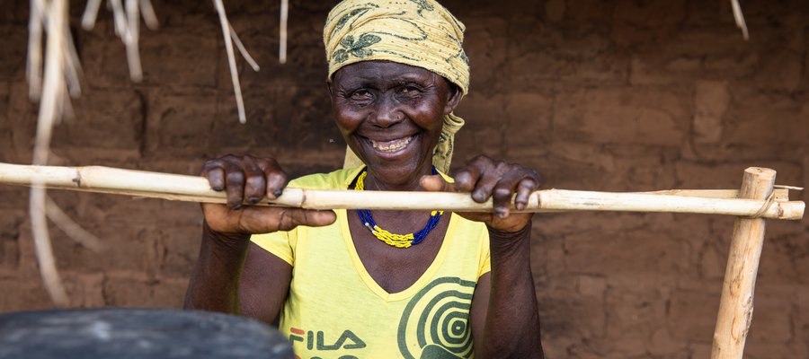 Joaquina leans over a fence, smiling at the camera