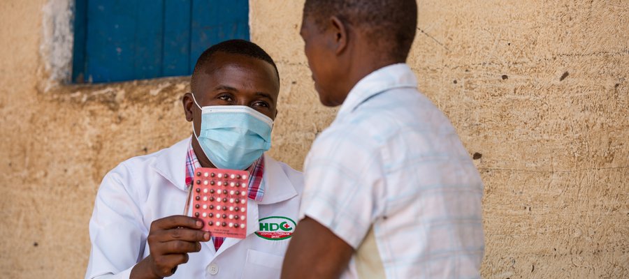 A doctor holds a pack of MDT