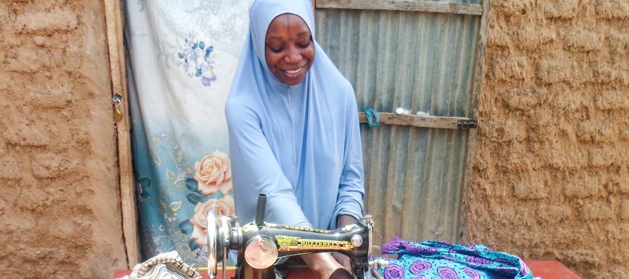 Mariama has received job training and is a skilled seamstress making clothes to sell