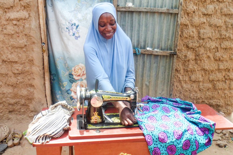 Mariama has received job training and is a skilled seamstress making clothes to sell