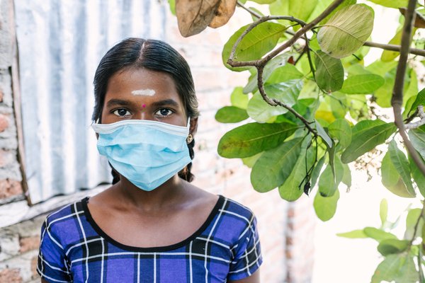 A girl in Sri Lanka wearing a face mask
