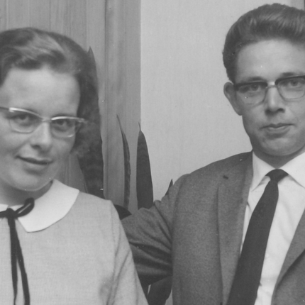 A black and white photo of a young, smartly dressed Dutch couple wearing glasses