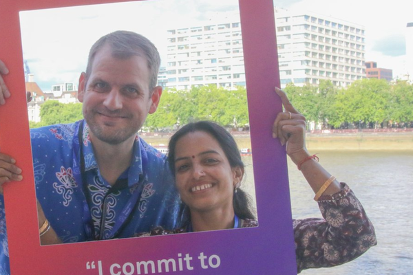 Two people smile at the camera.