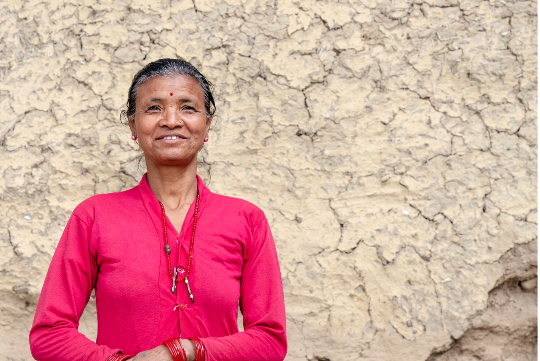 An older woman smiling at the camera.