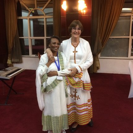 Tanny stands in white, traditional Ethiopian dress alongside Birke, the winner of the Wellesley Bailey Award